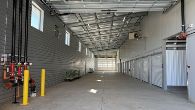 Storage unit drive-thru covered loading for drive-up storage units